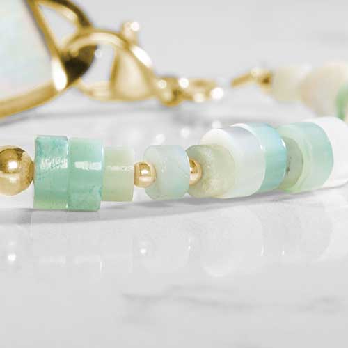 Close up of Amazonite, cream and gold beaded bracelet
