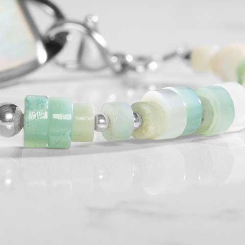 Close up of Amazonite, cream and silver beads.