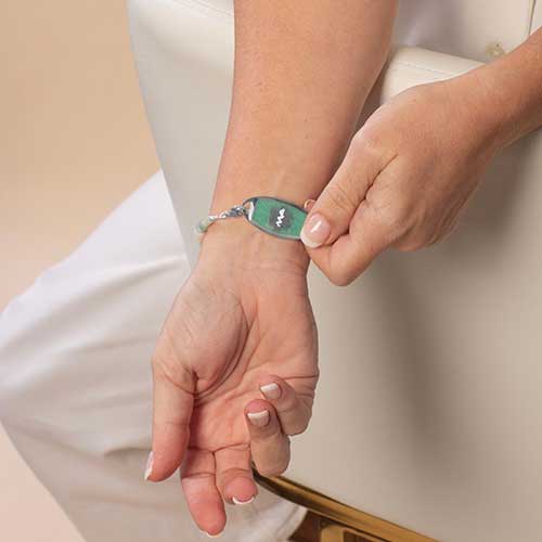 Amazonite inlaid on a medical ID tag, featuring a prominent medical alert symbol.