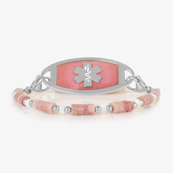 Beaded bracelet featuring Silver tone and Heishi beads in cream and rose on a stretch bracelet, attached to a Silver tone medical ID with a Silver tone medical ID tag with inlaid pink stone and Silver tone caduceus medical symbol. 