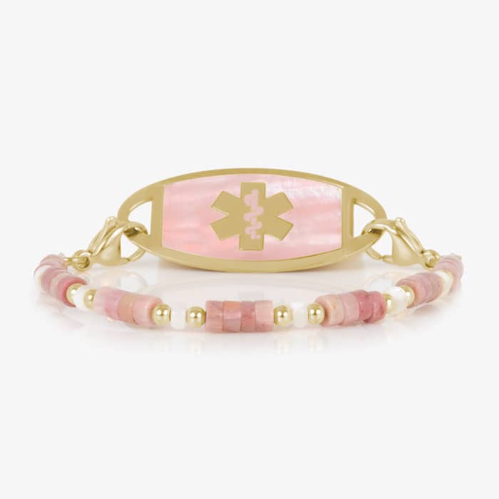 Beaded bracelet featuring gold tone and Heishi beads in cream and rose on a stretch bracelet, attached to a gold tone medical ID with a gold tone medical ID tag with Pink Mother of Pearl id and gold tone caduceus medical symbol. 