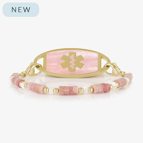 Beaded bracelet featuring gold tone and Heishi beads in cream and rose on a stretch bracelet, attached to a gold tone medical ID with a gold tone medical ID tag with Pink Mother of Pearl id and gold tone caduceus medical symbol. 