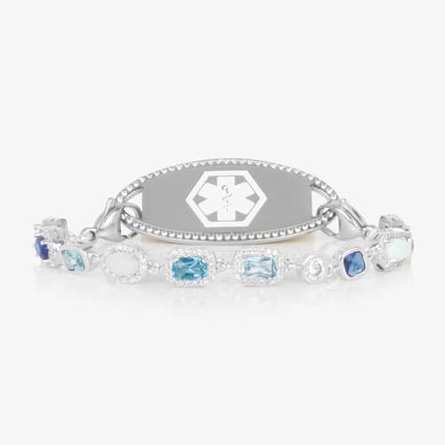 Rhodium and palladium plated medical ID bracelet with sapphire, topaz, aquamarine, quartz, and opal accents paired with silver tone medical ID tag with a border of CZ stones.