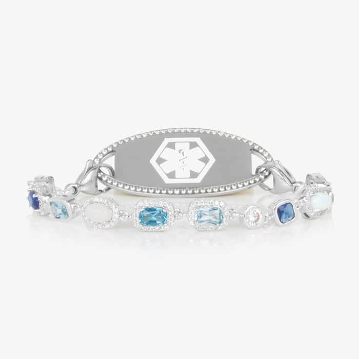 Rhodium and palladium plated medical ID bracelet with sapphire, topaz, aquamarine, quartz, and opal accents paired with silver tone medical ID tag with a border of CZ stones.