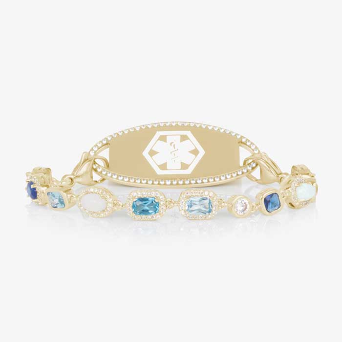 Gold medical ID bracelet with blue gemstone and pearl accents, featuring an engraved medical emblem for elegant everyday safety.