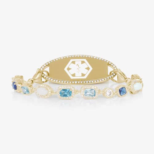 Gold medical ID bracelet with blue gemstone and pearl accents, featuring an engraved medical emblem for elegant everyday safety.