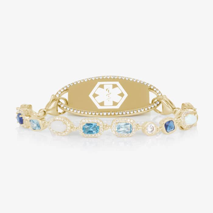 Gold medical ID bracelet with blue gemstone and pearl accents, featuring an engraved medical emblem for elegant everyday safety.
