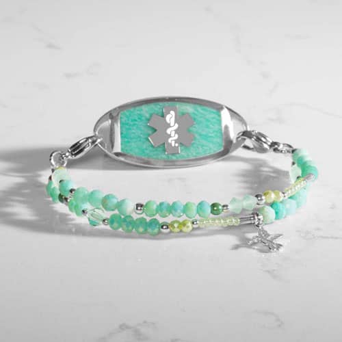 Beaded mint green and silver medical ID bracelet for women with a silver hummingbird charm, and a silver tone ID tag with a mint green amazonite stone inlay with a silver tone medical symbol
