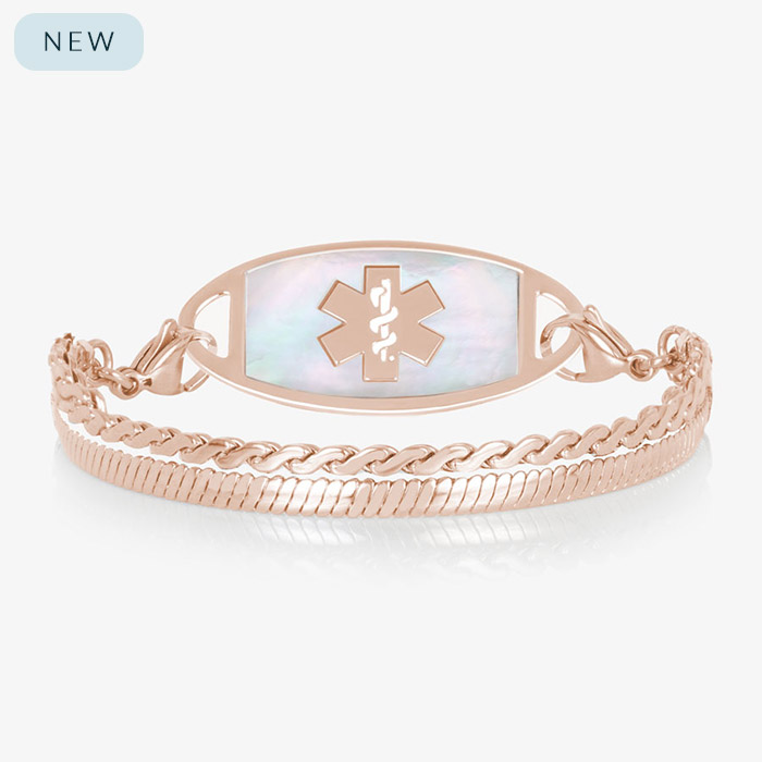 Rose gold medical ID bracelet with mother of pearl inlay tag and layered chain links on white background.