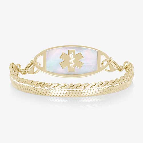 Gold medical ID bracelet with iridescent mother of pearl inlay tag and layered chain links on white background.