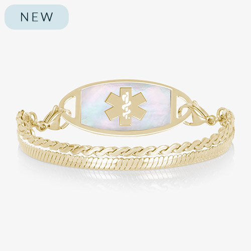 Gold medical ID bracelet with iridescent mother of pearl inlay tag and layered chain links on white background.