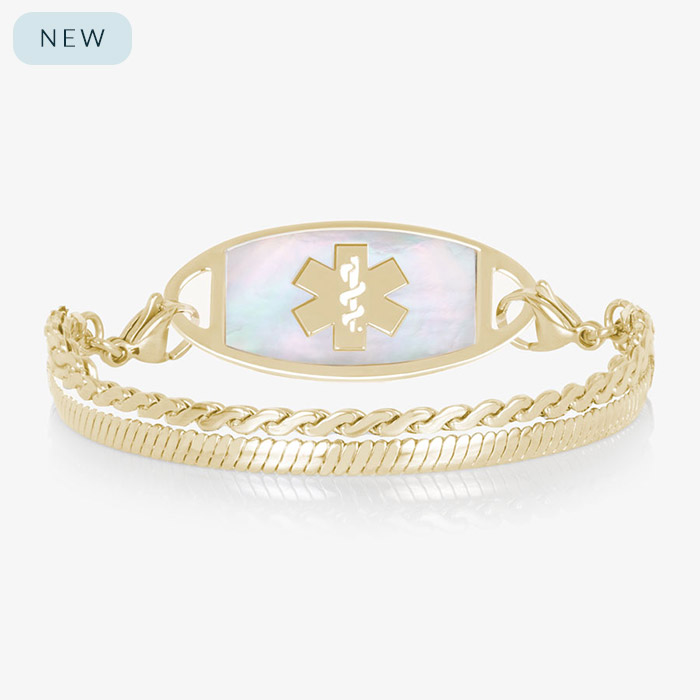 Gold medical ID bracelet with iridescent mother of pearl inlay tag and layered chain links on white background.