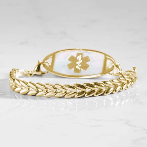 Gold-tone chevron link medical ID bracelet featuring a white mother-of-pearl inlay ID tag with a gold-tone Star of Life symbol.