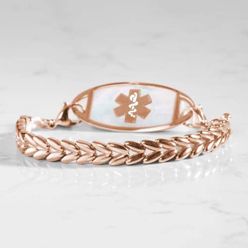 Rose gold-tone chevron link medical ID bracelet featuring a white mother-of-pearl inlay ID tag with the Star of Life symbol.