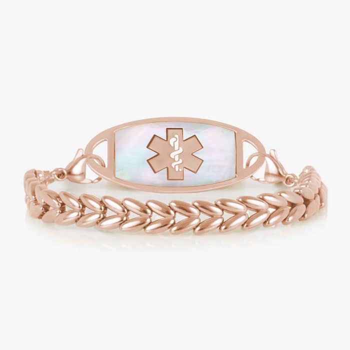 Rose gold-tone chevron link medical ID bracelet with a white mother-of-pearl inlay tag featuring the Star of Life symbol.