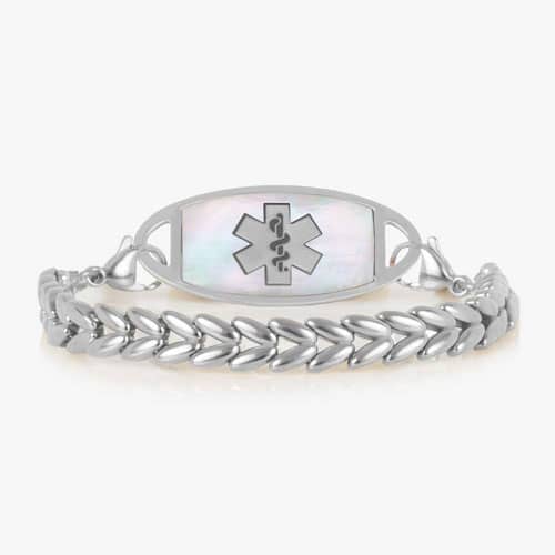 Oval medical ID tag with white inlay and medical symbol attached to a silver tone chevron link bracelet.