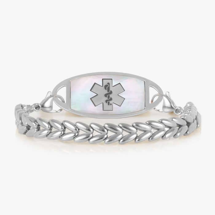Oval medical ID tag with white inlay and medical symbol attached to a silver tone chevron link bracelet.