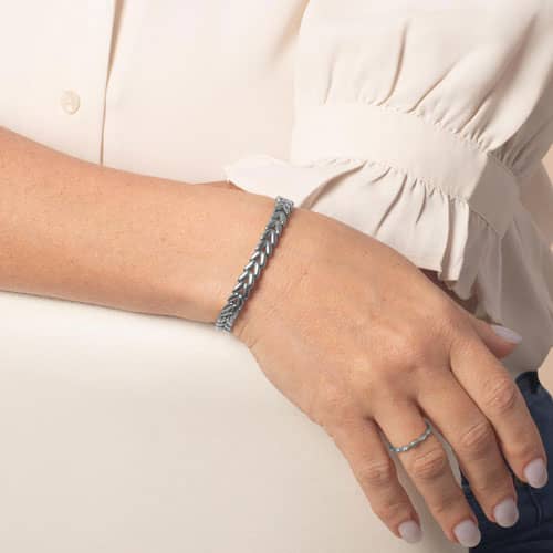 Model wearing a silver tone chevron link bracelet on wrist.