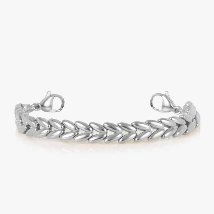 Oval medical ID tag with white inlay and medical symbol attached to a silver tone chevron link bracelet.