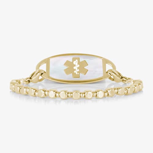 Front view of the Facet Gold interchangeable bracelet paired with a gold-tone medical ID tag featuring a white mother-of-pearl inlay.
