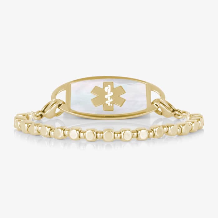 Front view of the Facet Gold interchangeable bracelet paired with a gold-tone medical ID tag featuring a white mother-of-pearl inlay.