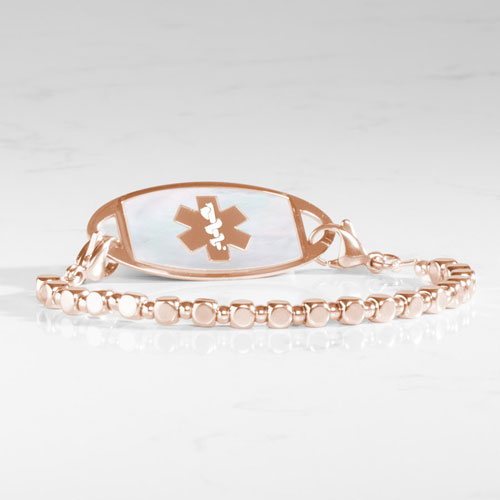 Facet Rose interchangeable bracelet paired with a rose gold-tone medical ID tag featuring a white mother-of-pearl inlay and medical alert symbol.