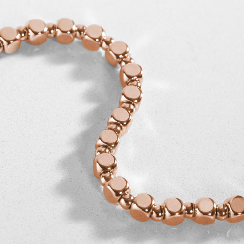 Close-up of the Facet Rose interchangeable bracelet featuring polished rose gold-tone faceted links with a clean, minimalist style.