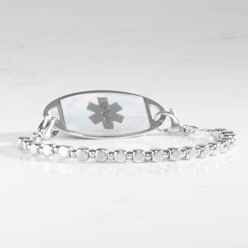 Facet Silver interchangeable bracelet paired with a silver medical ID tag featuring an iridescent mother-of-pearl inlay and medical alert symbol.