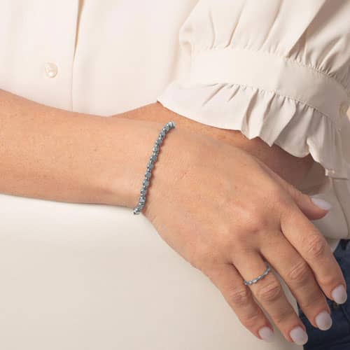 Woman wearing the Facet Silver interchangeable bracelet featuring polished silver-tone faceted links with a modern, minimalist style.