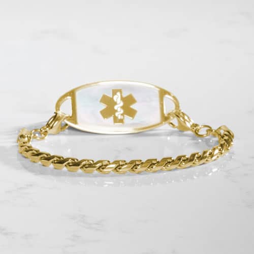 Angled view of the Faron Gold bracelet paired with a gold-tone medical ID tag featuring a white mother-of-pearl inlay.