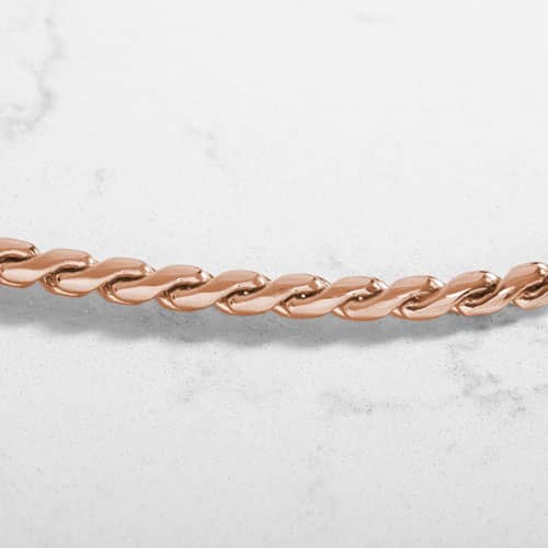 Close-up of the rose tone twisted chain bracelet links.