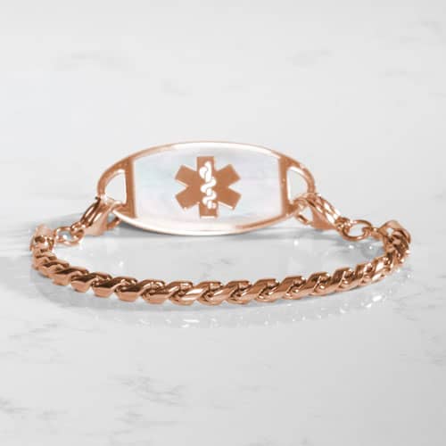 Oval medical ID tag with white inlay and medical symbol attached to a rose tone twisted chain bracelet.