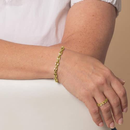 Gold Hadley link bracelet worn on the wrist.
