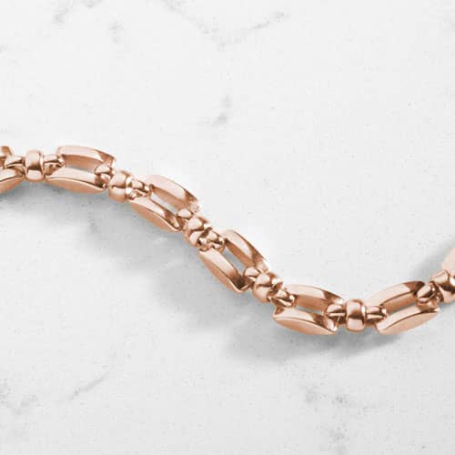 Close-up of the polished rose gold geometric links of the Hadley bracelet.