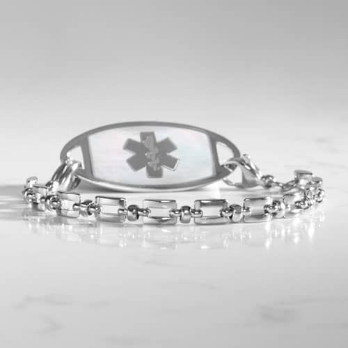Silver Hadley medical ID bracelet with mother-of-pearl tag photographed on a white marble surface.