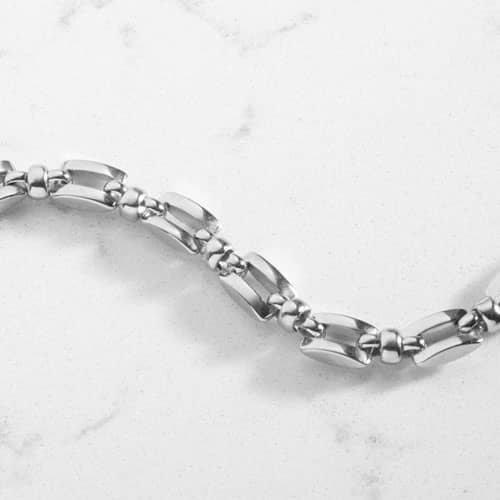 Close-up of the polished silver geometric links of the Hadley bracelet.