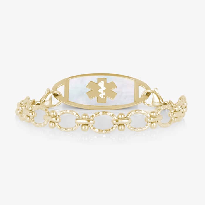 Gold-tone medical alert bracelet with a mother-of-pearl ID tag featuring the Star of Life symbol and elegant textured chain links.