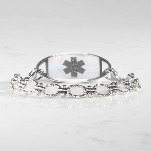 Silver-tone medical ID bracelet featuring textured oval links and a mother-of-pearl alert tag accented with the Star of Life symbol.