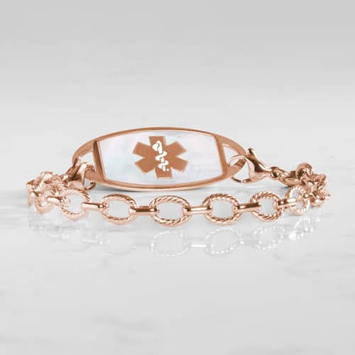 Rose gold medical alert bracelet paired with a mother-of-pearl ID tag featuring the Star of Life symbol and elegant chain links.