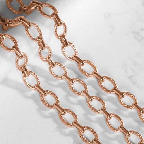 Close-up of the Ivy bracelet's textured rose gold oval chain links, highlighting the polished finish and interchangeable design.