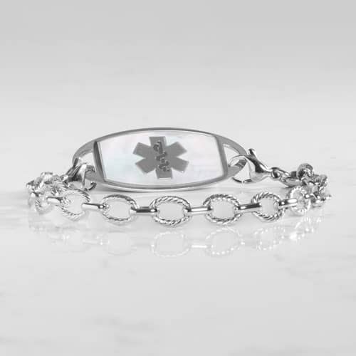 Silver medical alert bracelet paired with a mother-of-pearl ID tag featuring the Star of Life symbol and elegant chain links.