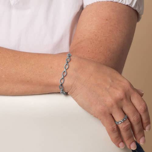 Woman wearing the Ivy silver chain bracelet, an elegant interchangeable style designed to pair with medical ID tags.