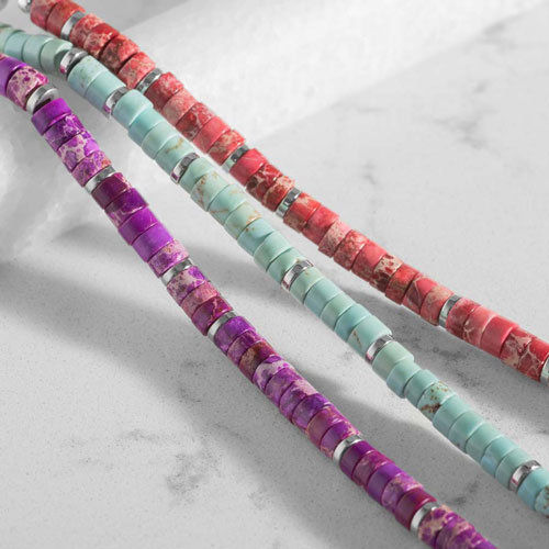 Pink, turquoise, and purple heishi bead medical ID bracelets displayed together, highlighting colorful natural stone bead options.