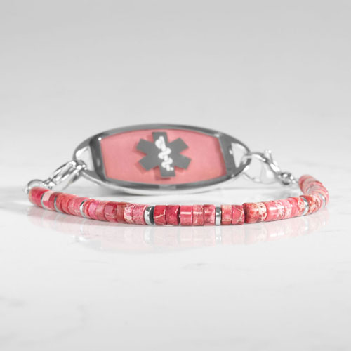 Silver-tone medical ID bracelet with pink jasper heishi beads, silver spacer accents, and a pink stone inlay ID tag featuring the Star of Life symbol.