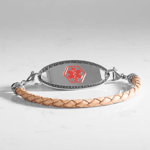 Angled view of a light tan braided bracelet with a silver-tone medical ID tag and red medical symbol.