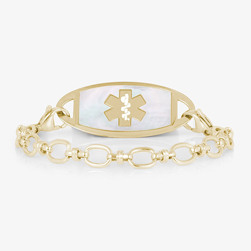 Gold-tone medical ID bracelet with oval-link chain and a white inlay ID tag featuring the medical symbol.