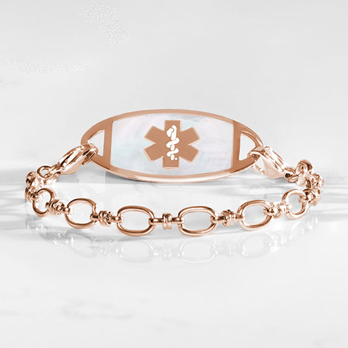Rose gold-tone medical ID bracelet with oval-link chain and white inlay tag featuring the medical symbol.