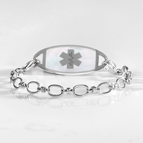 Silver-tone medical ID bracelet with oval-link chain and white inlay tag featuring the medical symbol.
