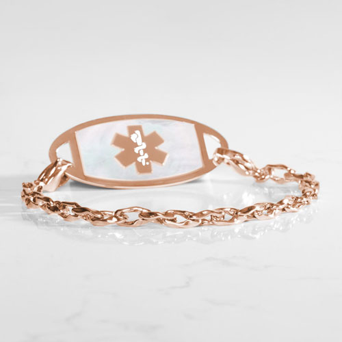 Rose gold-tone medical ID bracelet with interlocking chain links, light inlay, and a prominent medical symbol on the ID tag.