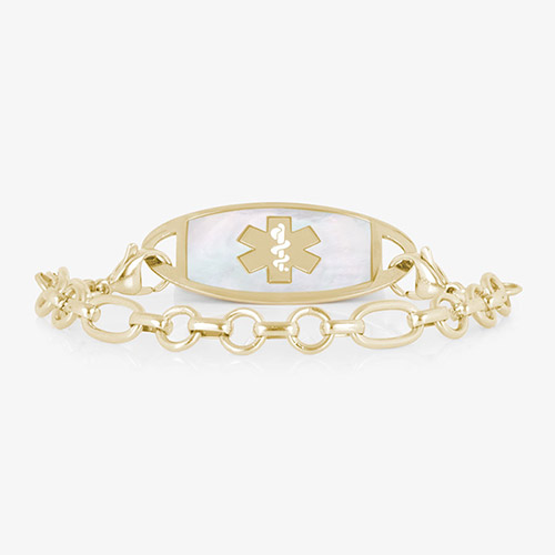Gold-tone medical ID bracelet with a white inlay tag, medical symbol, and alternating round and oval links.